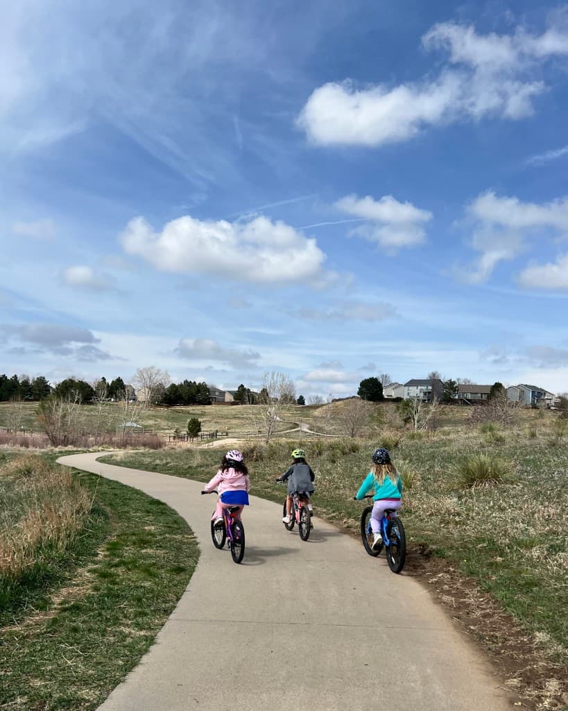Kids riding bikes together outdoors
